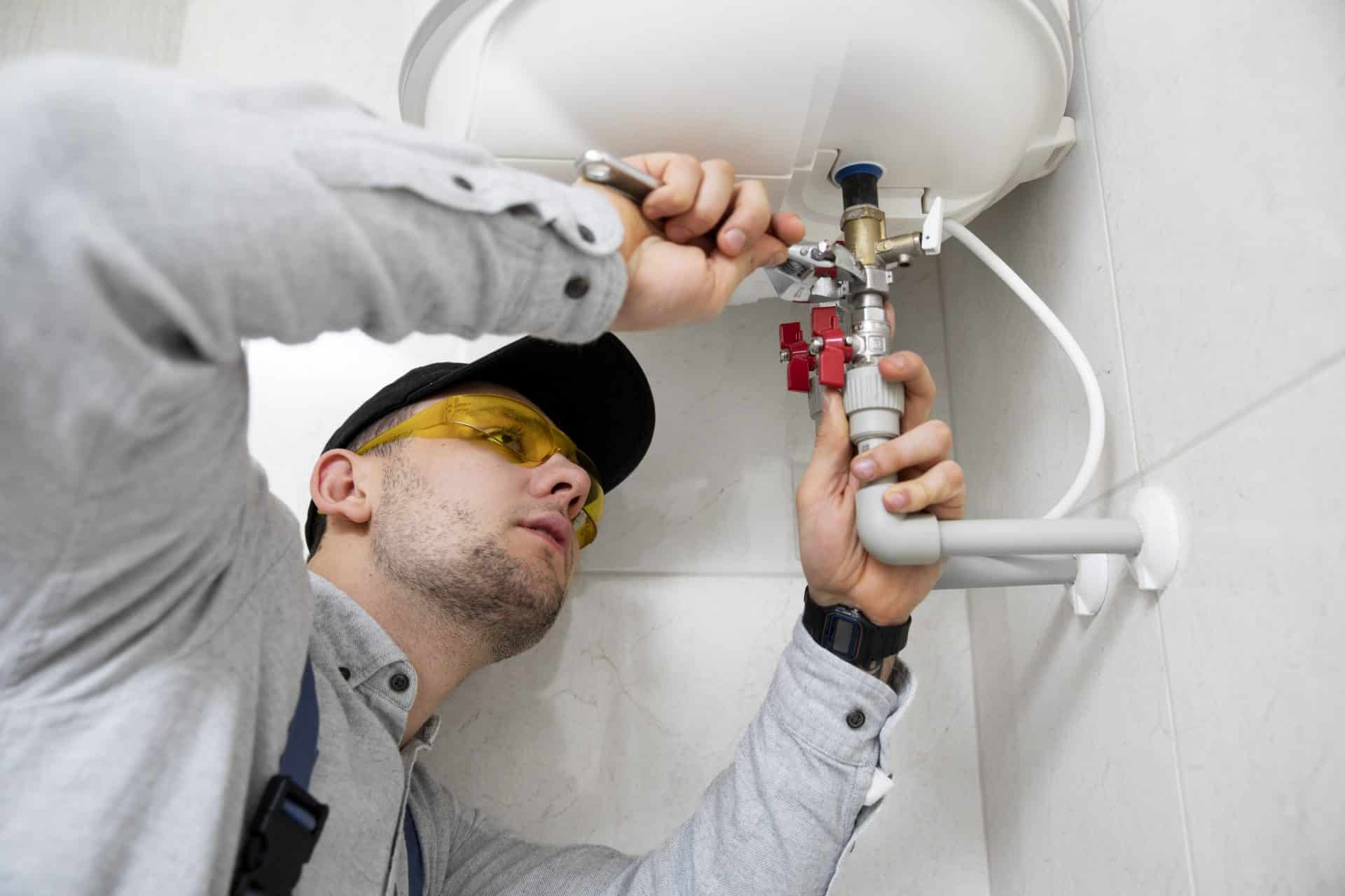 a plumber installs a boiler